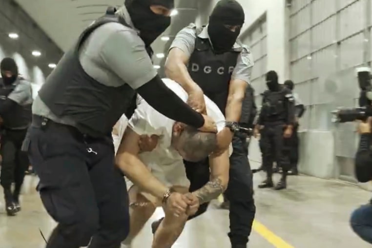 A man identified by Jennifer Vasquez Sura as her husband, Kilmar Abrego Garcia, is led by guards through the Terrorism Confinement Center in Tecoluca, El Salvador. 