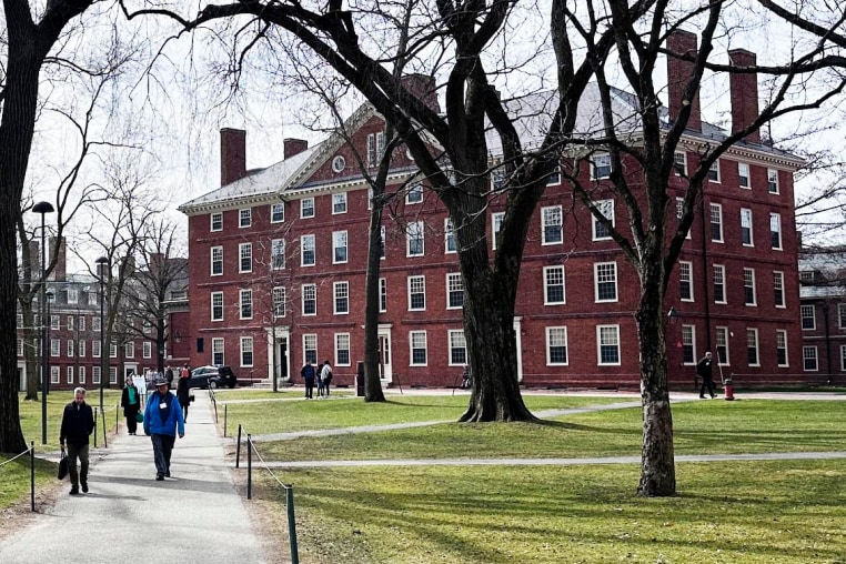 People walk through the campus of Harvard University in Cambridge, Mass., Tuesday, March 18, 2025.