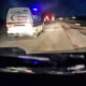 A Red Crescent ambulance with its emergency lights flashing drives toward a fire truck and other ambulances in Rafah, Gaza