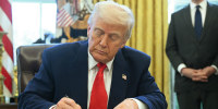 President Donald Trump signs an executive order in the Oval Office on April 9, 2025.
