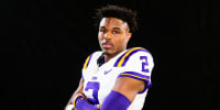 Kyren Lacy in his football uniform poses against a black background