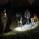 A National Guardswoman speaks to three unaccompanied children who had just arrived on the banks of the Rio Grande in Roma, Texas, after crossing the Mexico border on a raft on July 9, 2021. 