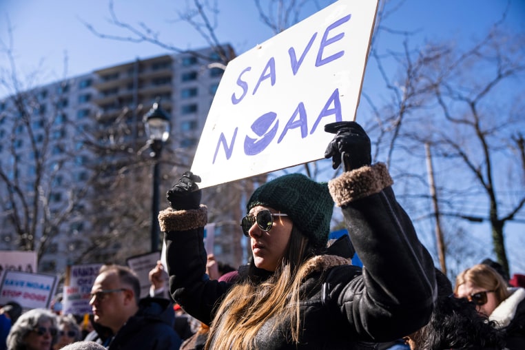 Demonstrators attend a rally outside National Oceanic and Atmospheric Administration headquarters to oppose the recent worker firings in Silver Spring, Md., on March 3, 2025. 